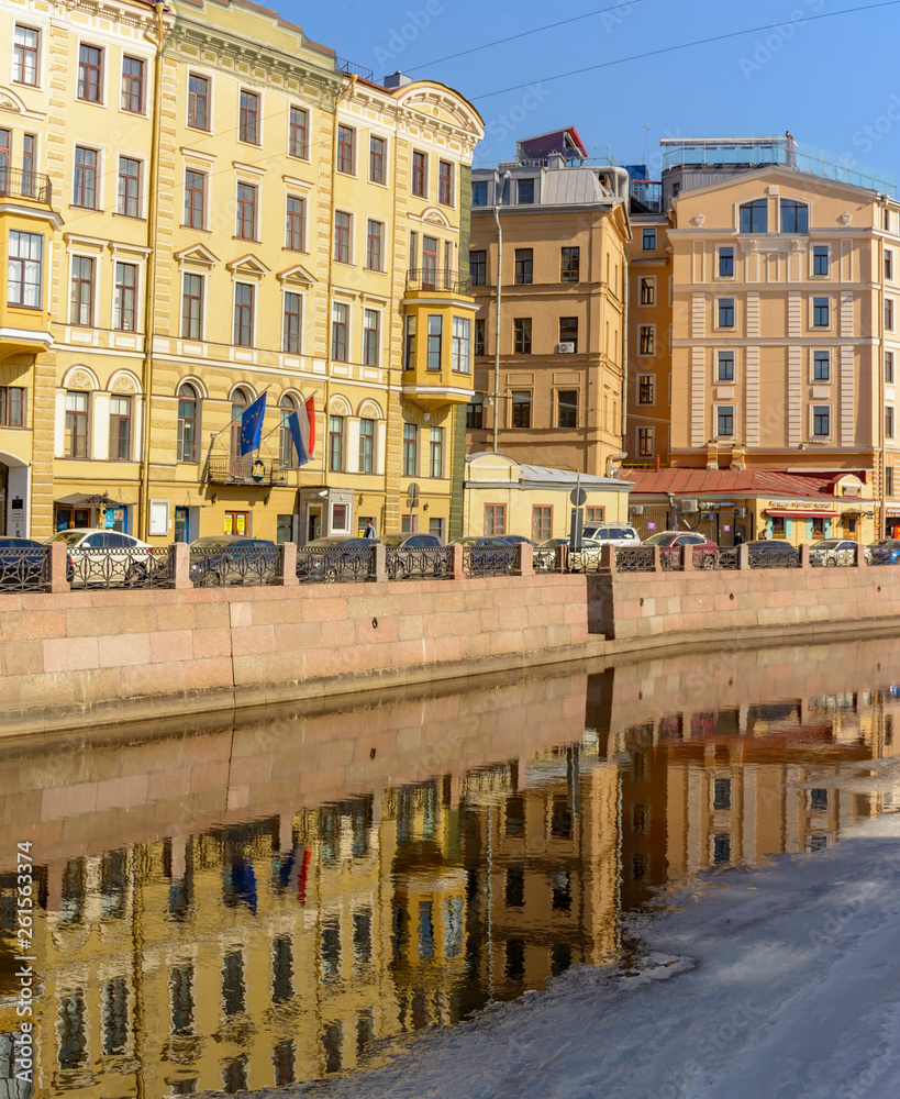 Reflections of houses in the river Moika Sunny April day in St. Petersburg.