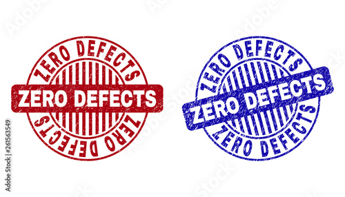 Grunge ZERO DEFECTS round stamp seals isolated on a white background. Round seals with grunge texture in red and blue colors.