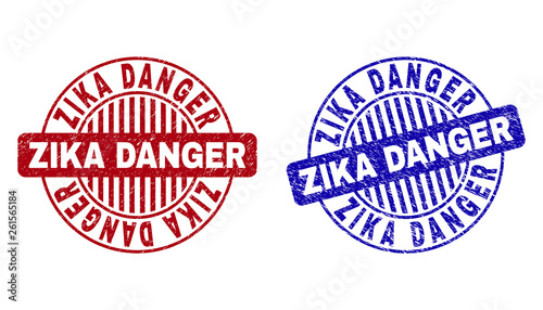 Grunge ZIKA DANGER round stamp seals isolated on a white background. Round seals with grunge texture in red and blue colors. Vector rubber imprint of ZIKA DANGER tag inside circle form with stripes.