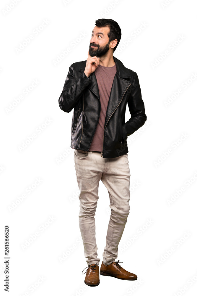 Handsome man with beard thinking an idea while looking up over isolated white background Handsome man with beard thinking an idea while looking up over isolated white background
