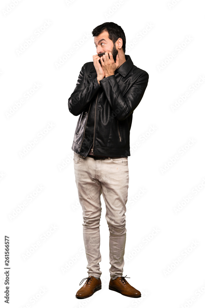 Handsome man with beard nervous and scared putting hands to mouth over isolated white background Handsome man with beard nervous and scared putting hands to mouth over isolated white background