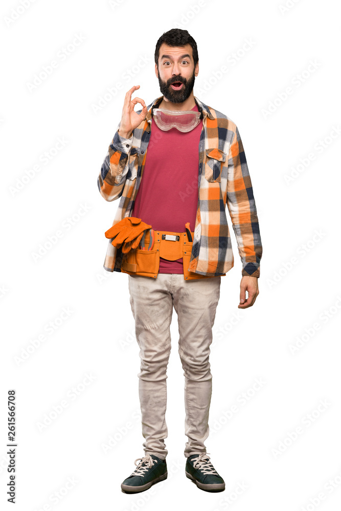 Craftsmen man surprised and showing ok sign over isolated white background Craftsmen man surprised and showing ok sign over isolated white background