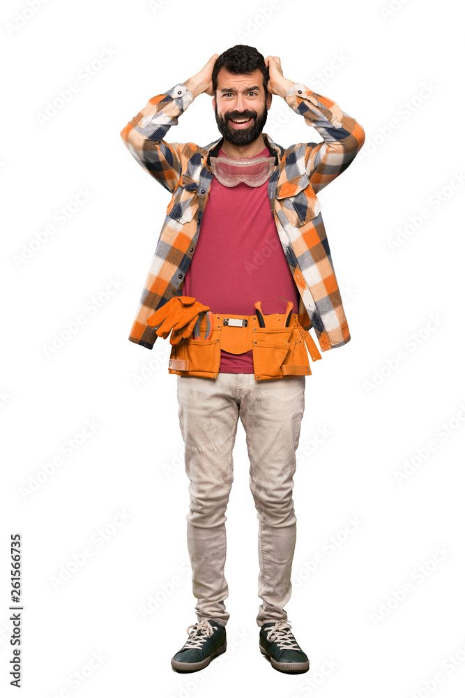Craftsmen man frustrated and takes hands on head over isolated white background Craftsmen man frustrated and takes hands on head over isolated white background