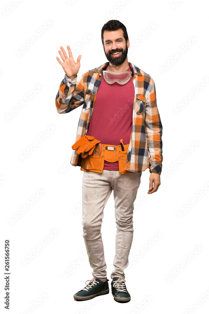 Craftsmen man saluting with hand with happy expression over isolated white background Craftsmen man saluting with hand with happy expression over isolated white background