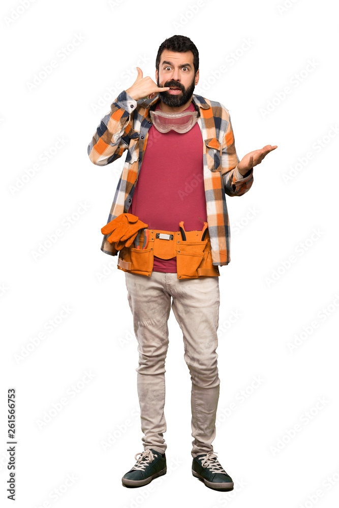 Craftsmen man making phone gesture and doubting over isolated white background Craftsmen man making phone gesture and doubting over isolated white background
