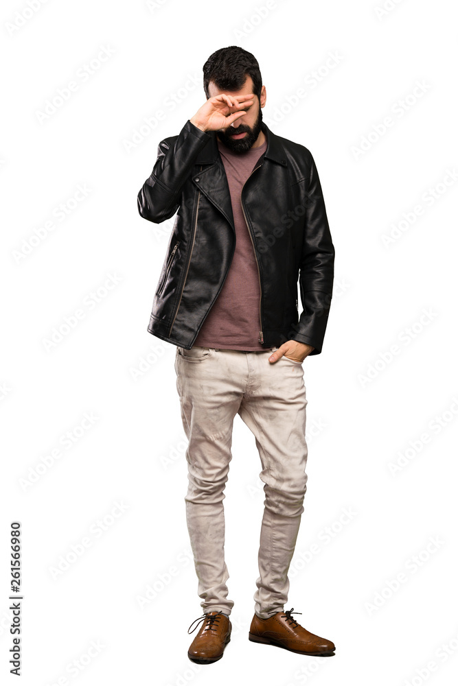 Handsome man with beard with tired and sick expression over isolated white background Handsome man with beard with tired and sick expression over isolated white background