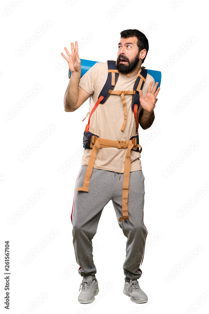 Hiker man nervous and scared over isolated white background Hiker man nervous and scared over isolated white background
