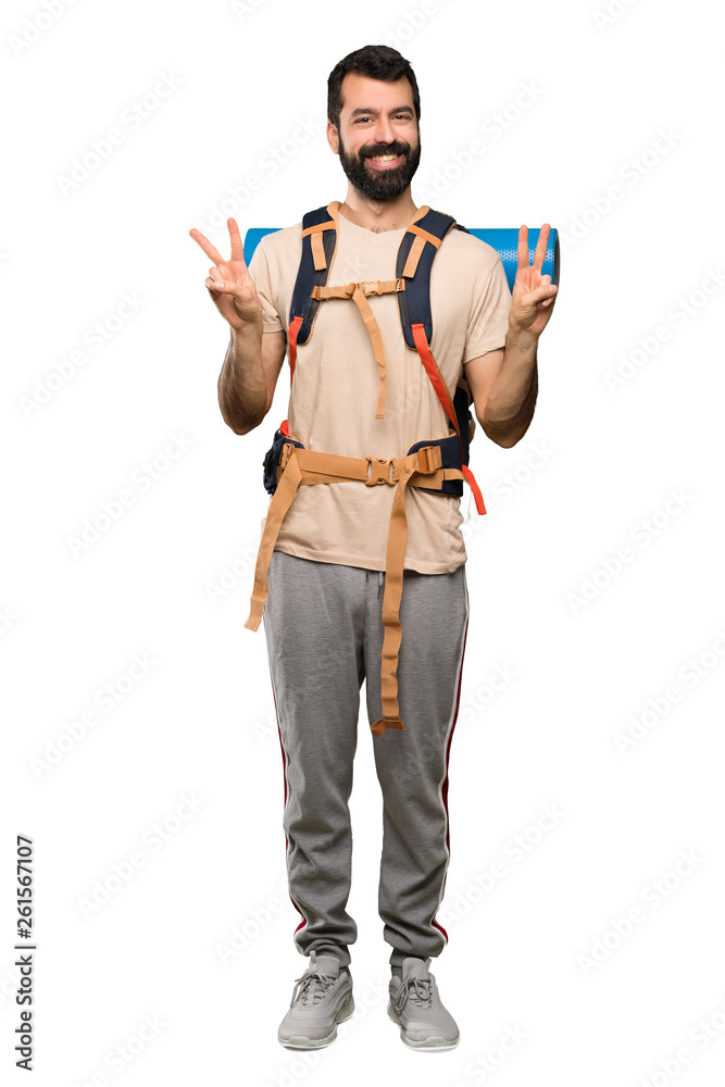 Hiker man showing victory sign with both hands over isolated white background Hiker man showing victory sign with both hands over isolated white background
