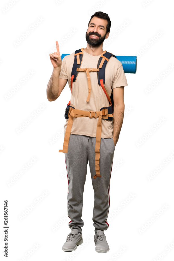 Hiker man showing and lifting a finger in sign of the best over isolated white background Hiker man showing and lifting a finger in sign of the best over isolated white background