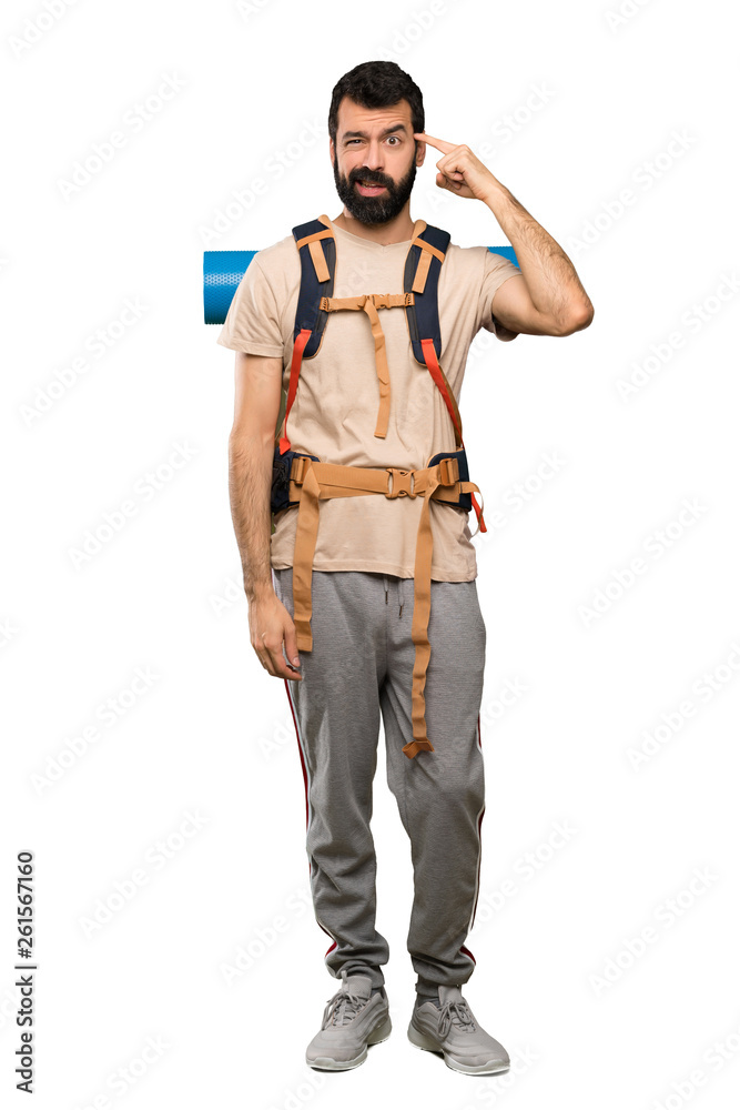 Hiker man making the gesture of madness putting finger on the head over isolated white background Hiker man making the gesture of madness putting finger on the head over isolated white background
