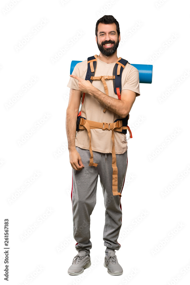 Hiker man pointing to the side to present a product over isolated white background
