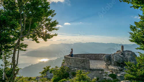 Cute young girl admiring the scenery from the viewpoint.