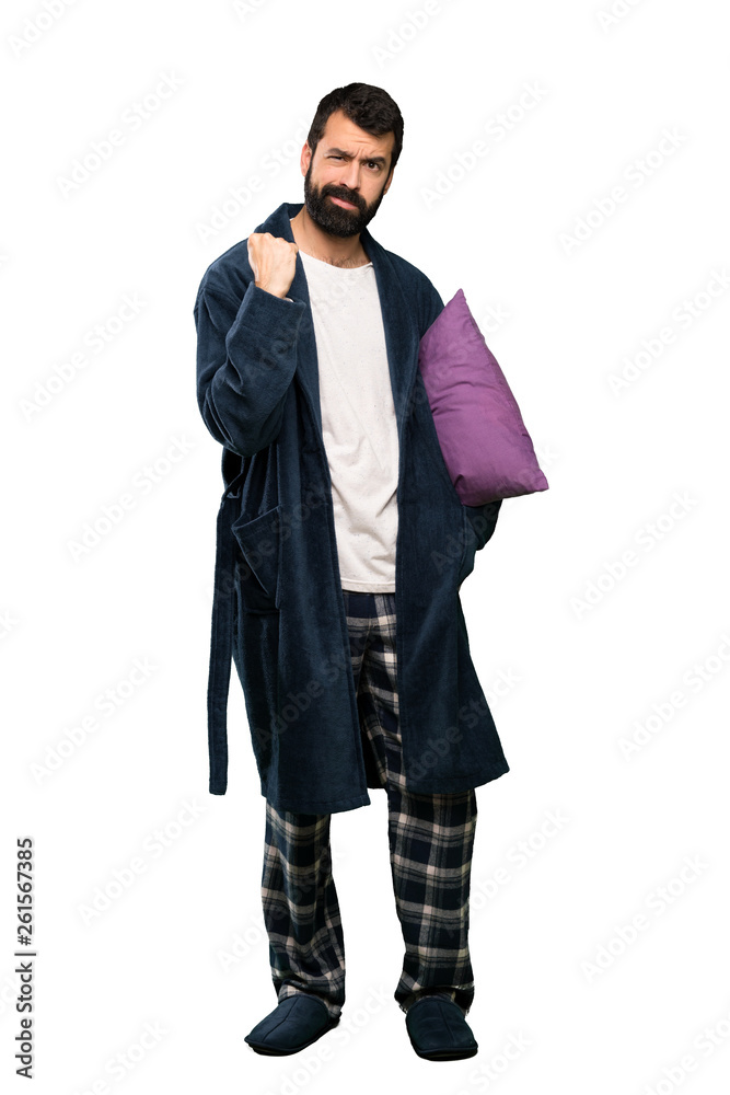 Man with beard in pajamas with angry gesture over isolated white background Man with beard in pajamas with angry gesture over isolated white background
