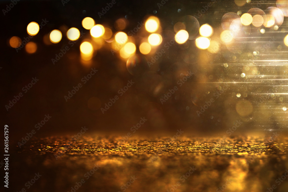 glitter vintage lights background. black and gold. de-focused