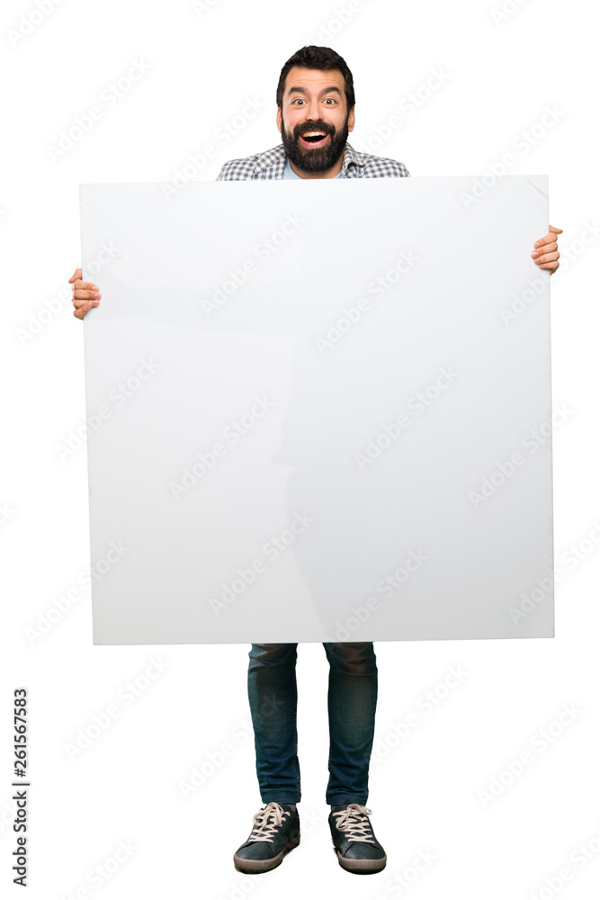 Happy Handsome man with beard holding an empty placard Happy Handsome man with beard holding an empty placard