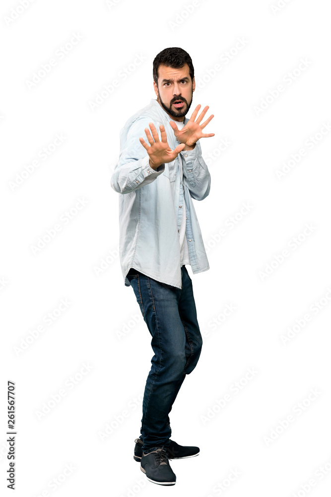 Full-length shot of Handsome man with beard nervous stretching hands to the front over isolated white background Full-length shot of Handsome man with beard nervous stretching hands to the front over isolated white background