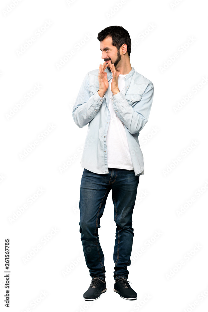 Full-length shot of Handsome man with beard scheming something over isolated white background Full-length shot of Handsome man with beard scheming something over isolated white background