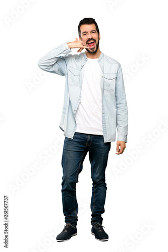 Full-length shot of Handsome man with beard making phone gesture. Call me back sign over isolated white background