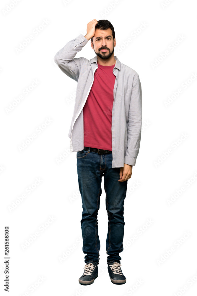 Full-length shot of Handsome man with beard with an expression of frustration and not understanding over isolated white background Full-length shot of Handsome man with beard with an expression of frustration and not understanding over isolated white background