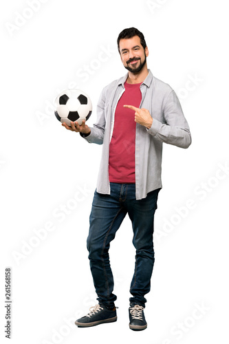 Handsome man with beard holding a soccer ball