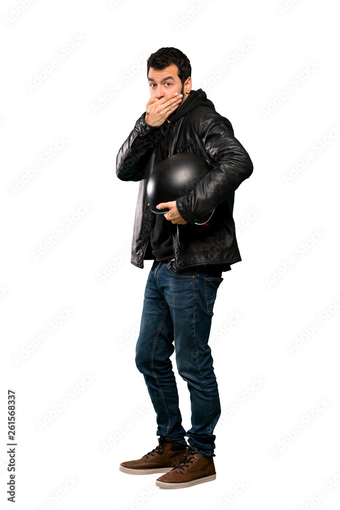 Full-length shot of Biker man covering mouth with hands over isolated white background
