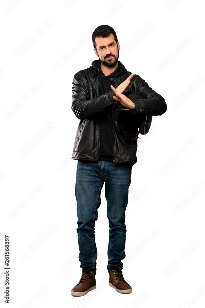 Full-length shot of Biker man making NO gesture over isolated white background Full-length shot of Biker man making NO gesture over isolated white background