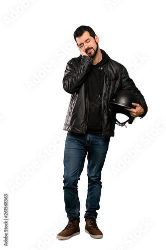 Full-length shot of Biker man making sleep gesture in dorable expression over isolated white background
