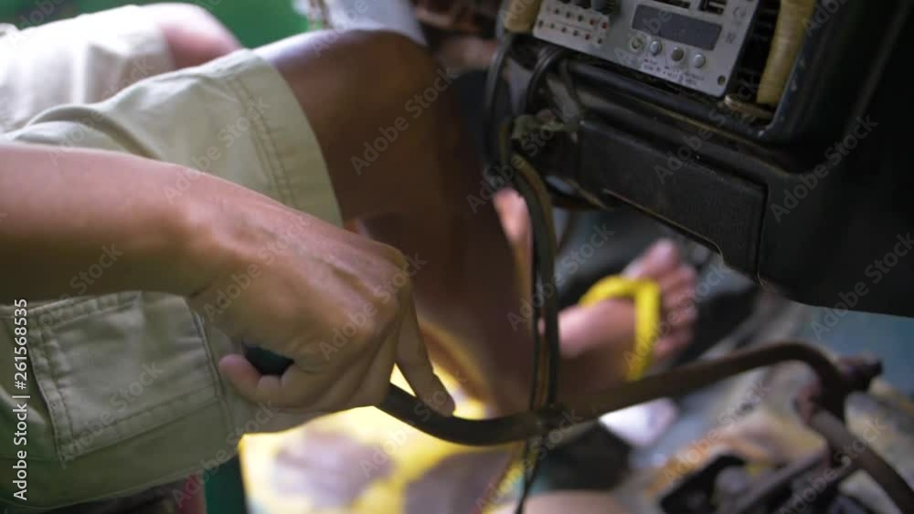 Driver wearing shorts and flip flops shifts gears of a truck carrying passengers to their destination. Feet work brake, clutch and gas pedals in a vehicle with manual transmission. Slow motion.