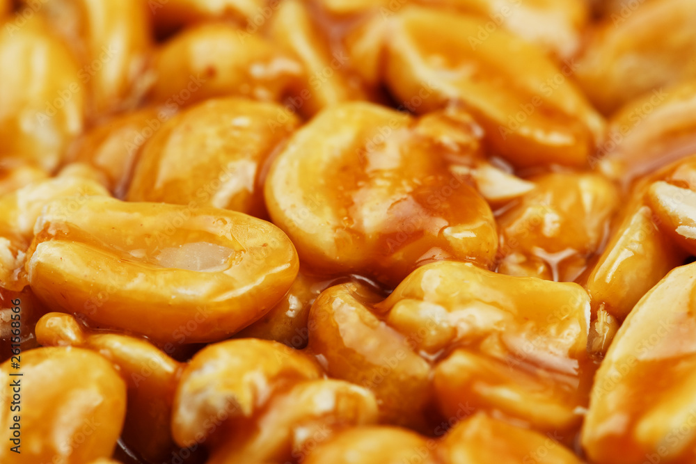 Kozinaki from golden, roasted peanuts beans as a background, texture. Macro shooting, close-up. Place for text Kozinaki from golden, roasted peanuts beans as a background, texture. Macro shooting, close-up. Place for text