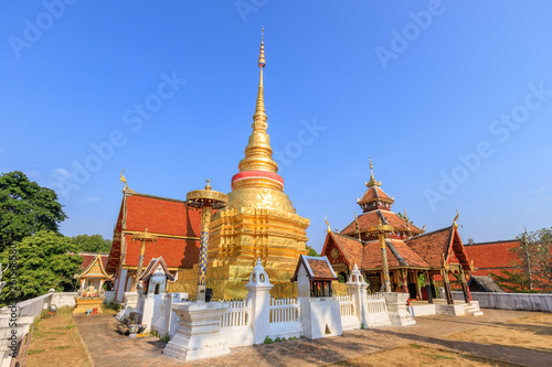 Golden pagoda and Buddha pavilion at Wat Pong Sanuk temple and museum in Lampang, North of Thailand © wirojsid