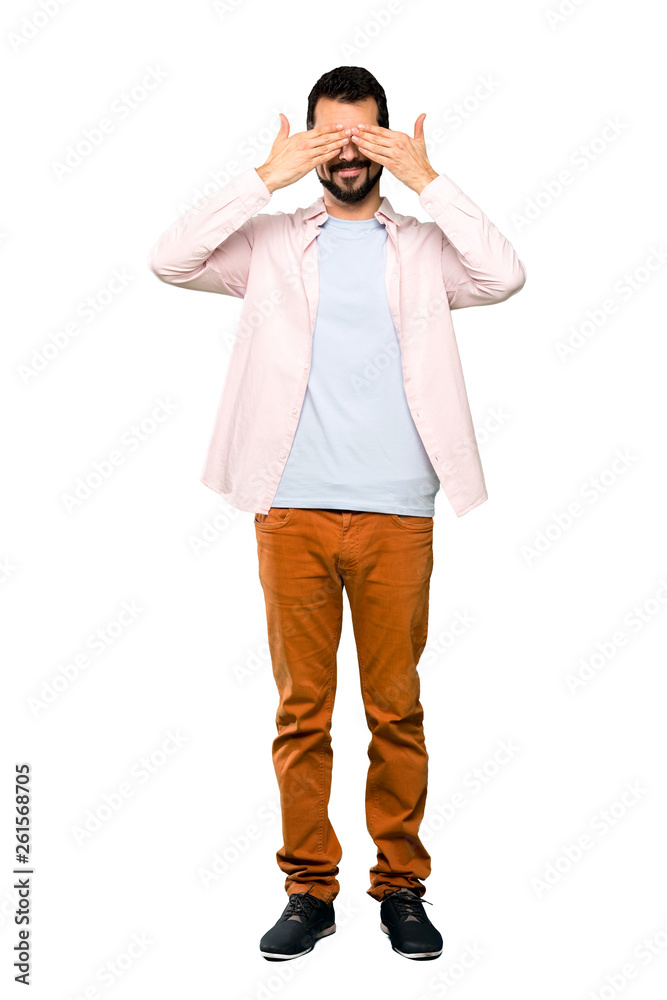 Full-length shot of Handsome man with beard covering eyes by hands over isolated white background Full-length shot of Handsome man with beard covering eyes by hands over isolated white background
