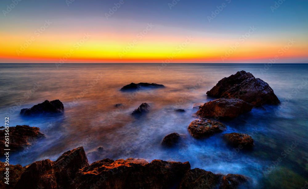Beautiful sunrise over rocky shore