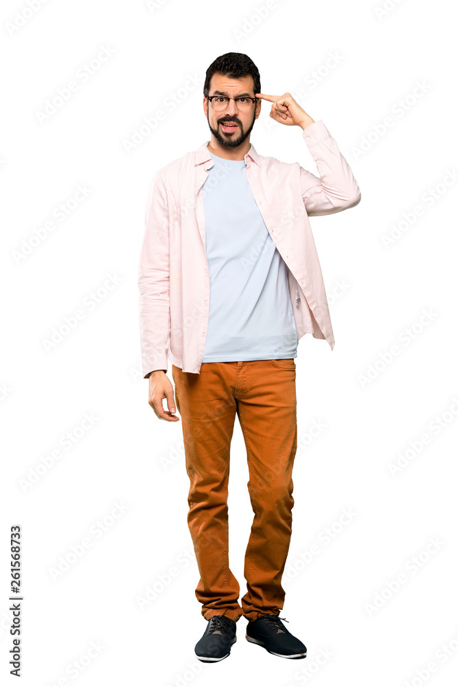 Full-length shot of Handsome man with beard making the gesture of madness putting finger on the head over isolated white background Full-length shot of Handsome man with beard making the gesture of madness putting finger on the head over isolated white background