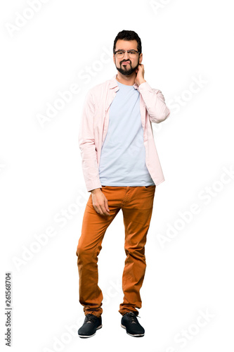 Full-length shot of Handsome man with beard having doubts over isolated white background