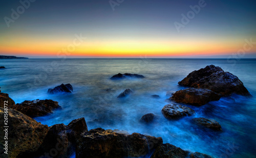 Beautiful sunrise over rocky shore © phadventure