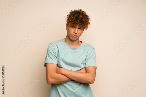 African american man with green shirt feeling upset © luismolinero