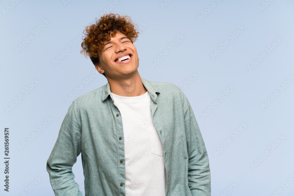 Young african american man over isolated blue wall smiling Young african american man over isolated blue wall smiling