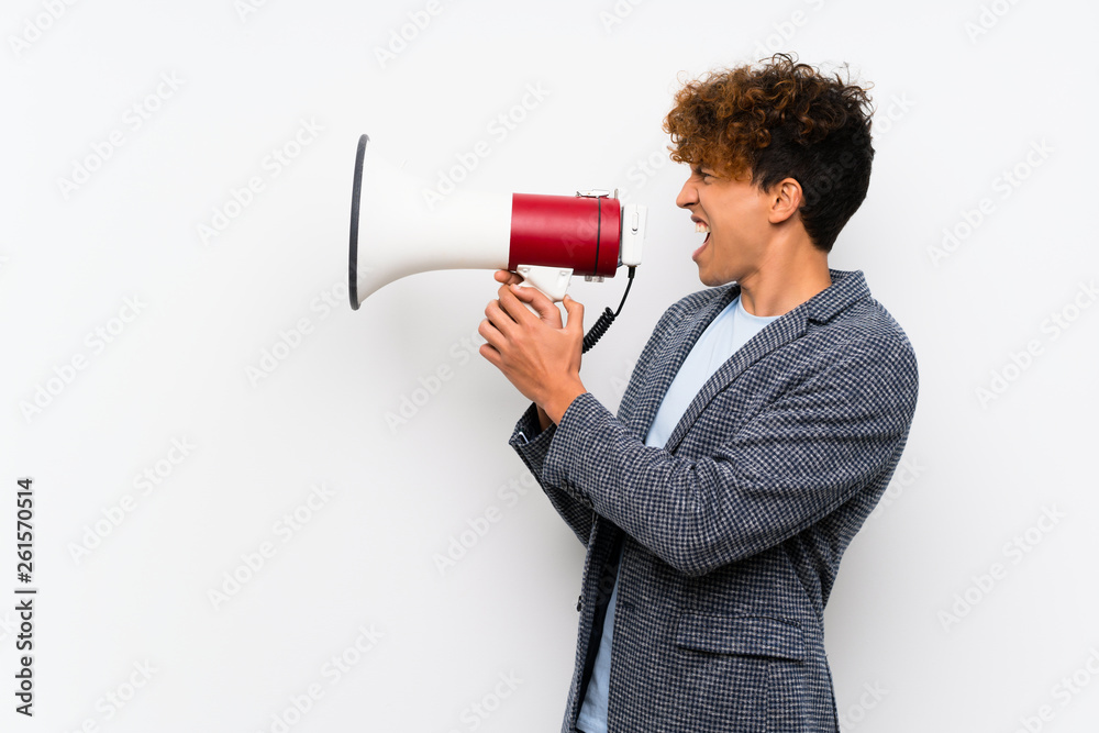 Fashion african american man over isolated white wall shouting through a megaphone Fashion african american man over isolated white wall shouting through a megaphone