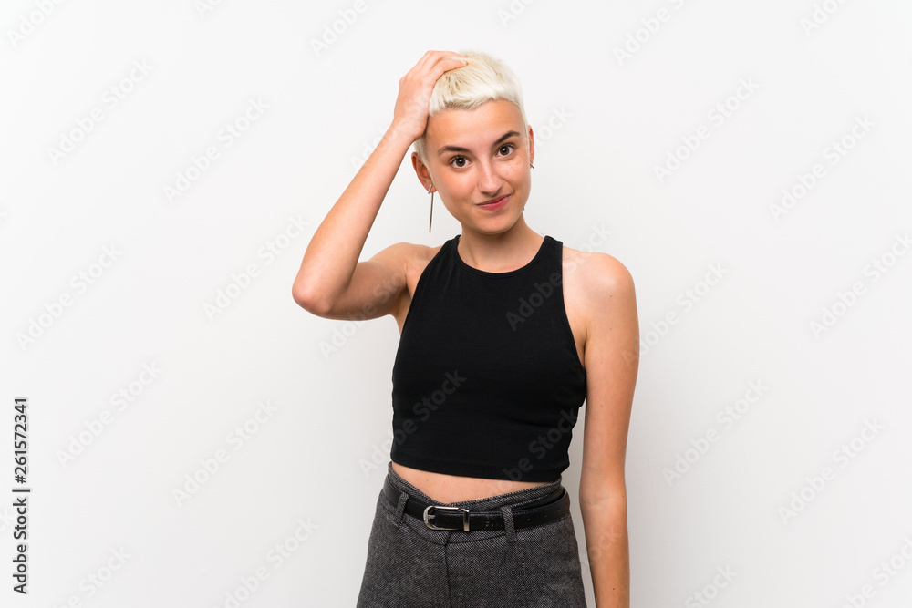 Teenager girl with short hair over white wall with an expression of frustration and not understanding Teenager girl with short hair over white wall with an expression of frustration and not understanding
