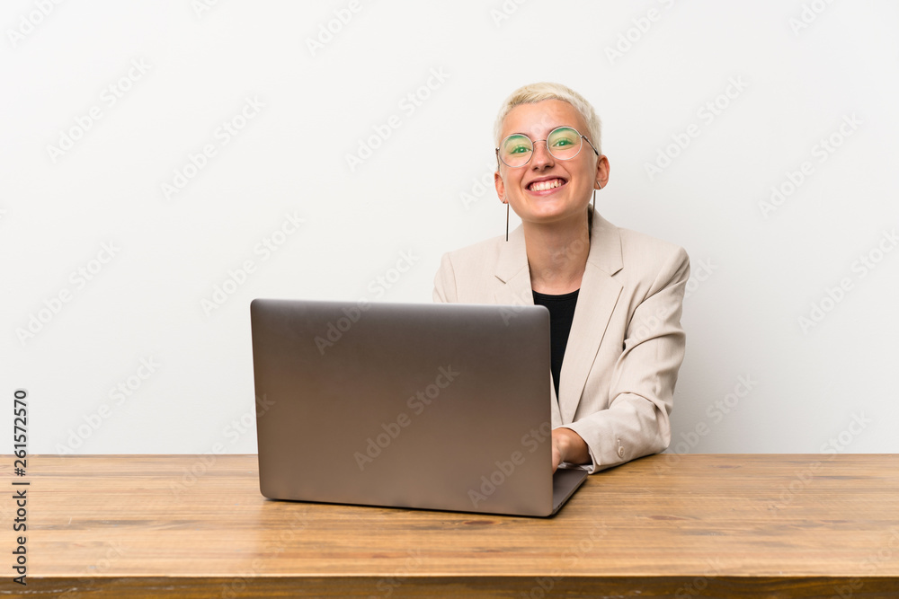 Happy Teenager girl with short hair with a laptop Happy Teenager girl with short hair with a laptop
