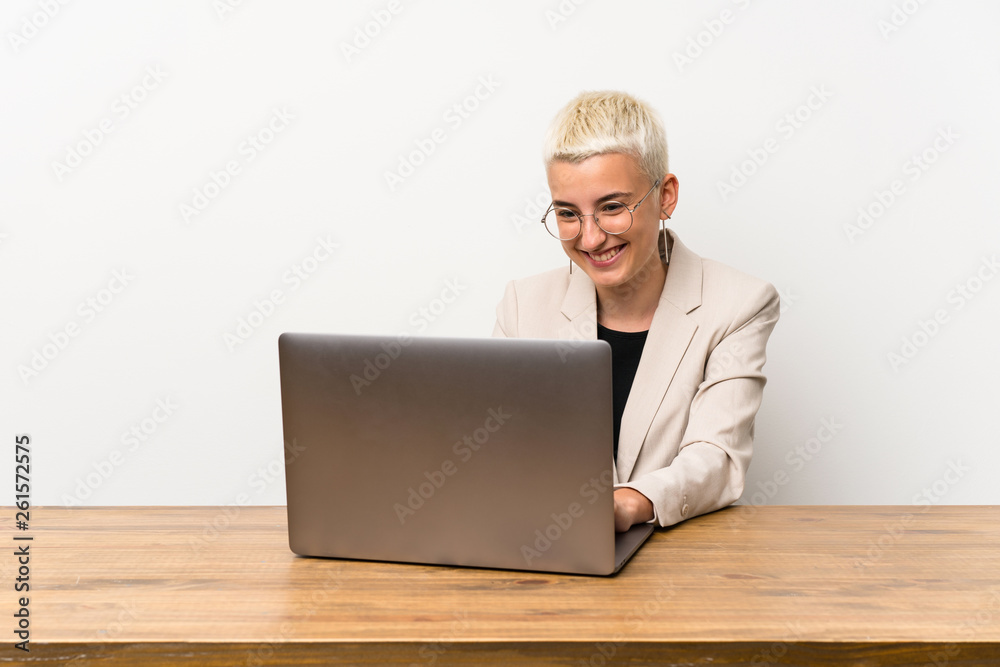 Happy Teenager girl with short hair with a laptop Happy Teenager girl with short hair with a laptop