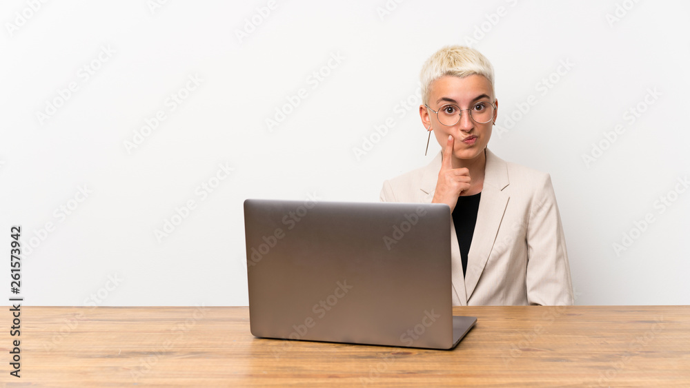 Teenager girl with short hair with a laptop Looking front Teenager girl with short hair with a laptop Looking front