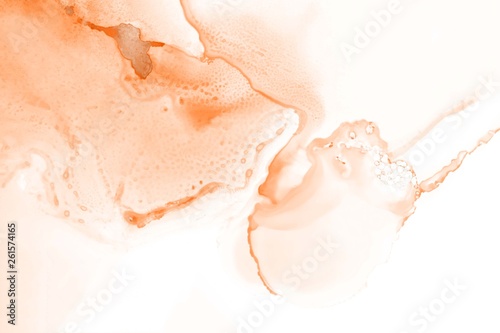 Orange alcohol ink texture with abstract washes and paint stains on the white paper background. 