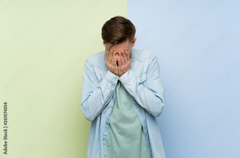 Redhead man over colorful background with tired and sick expression Redhead man over colorful background with tired and sick expression