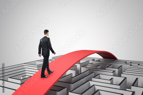 Businessman overcoming maze photo