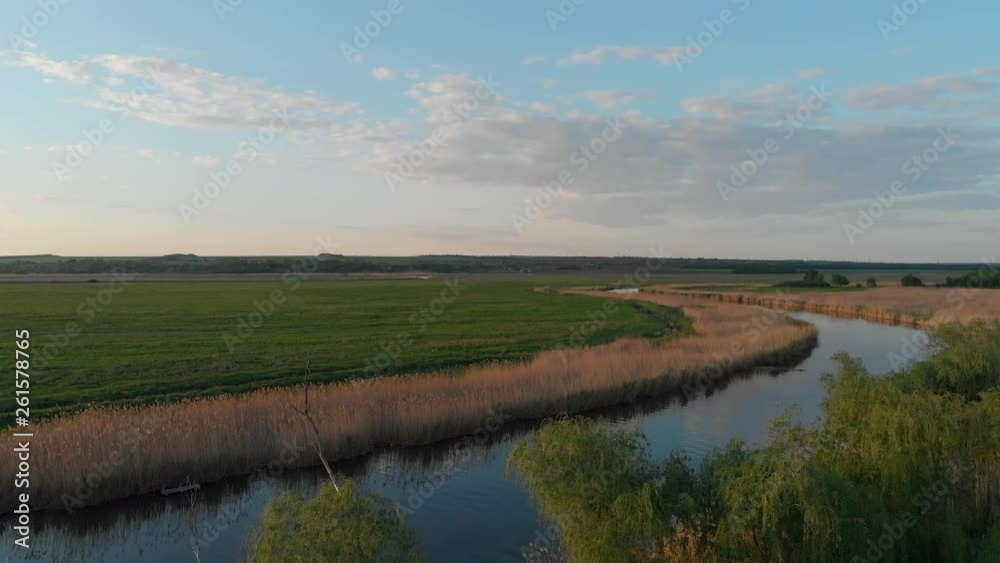 Quiet warm spring evening on the banks of the river. Rising aerial view Quiet warm spring evening on the banks of the river. Rising aerial view