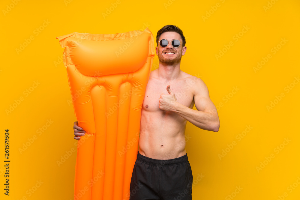 Redhead man in summer holidays giving a thumbs up gesture Redhead man in summer holidays giving a thumbs up gesture