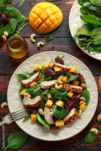 Grilled Chicken Mango salad with nuts and vegetables. Healthy food.