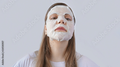 beautiful and cute girl in mask, skin care and moisturizing, with lemon, white background 
