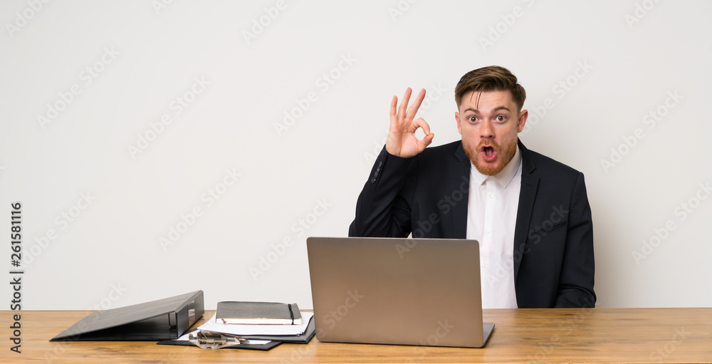 Businessman in a office surprised and showing ok sign Businessman in a office surprised and showing ok sign